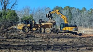 excavator loading into an articulated dump truck